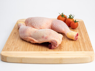 Raw chicken legs on a cutting board. Chicken legs on a white background.