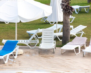 Sunbeds and deck chairs by the pool.