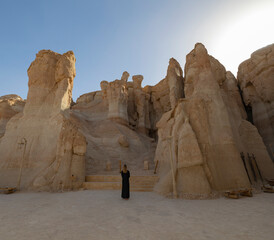Tourist looking up at the rock formations at the Al Qarah Caves, Al ahsa Eastern Province Saudi Arabia
