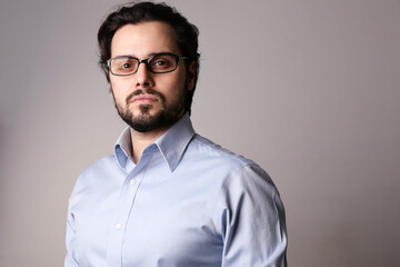 Young business man standing in corporate portrait isolated on white background