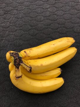 a bunch of bananas on a dark background
