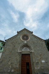Fototapeta na wymiar Corniglia Cinque Terre national park colorful houses church blue sky