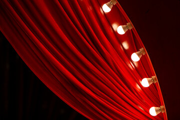 red curtain background with light bulbs