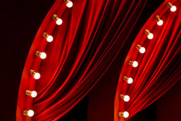 red curtain background with light bulbs