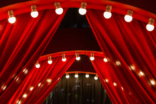 red curtain background with light bulbs