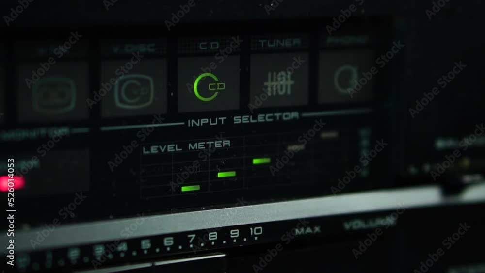 Poster cd input selector and volume level meter signal on vintage 1980s audio amplifier close up