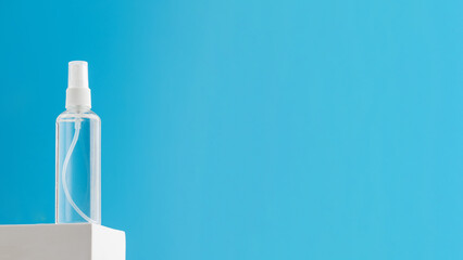 Spray mockup with micellar water, moisturizing skin lotion on a white pedestal on a blue background. Copy space 