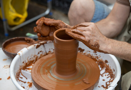 Man making ceramic pot..Master making clay pottery..Potter's hands working clay on a potter's wheel.