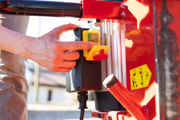 Female Hands operating With Power On Off Switch of an Agriculture Machinery