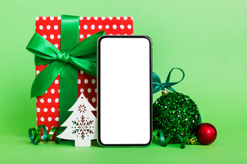 Digital phone mock up with rustic Christmas decorations for app presentation with empty space for...