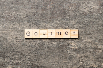 gourmet word written on wood block. gourmet text on cement table for your desing, concept