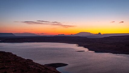 Morning golden sunrise over the rocky desert mountains of Lake Powell in northern Page Arizona