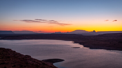 Morning golden sunrise over the rocky desert mountains of Lake Powell in northern Page Arizona