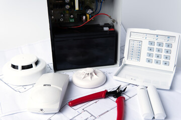Fire safety system construction. Smoke detector on blueprint drawing background. Fire protection,...