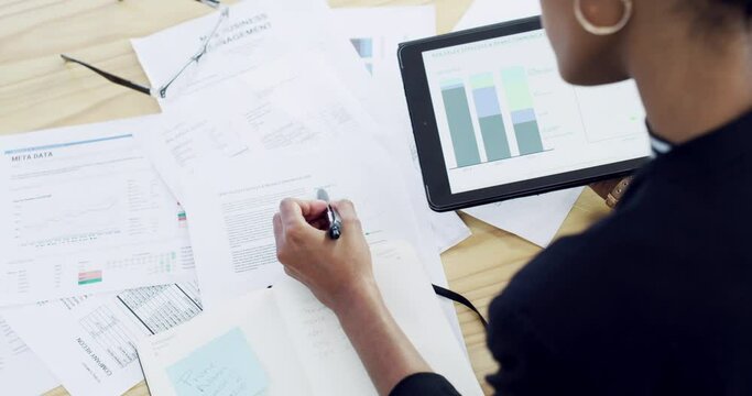 Finance business woman working on digital tablet, planning with paperwork and financial data for company growth in an office at work. Accountant writing strategy on paper and doing audit with graphs