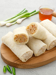 Lumpia or lunpia, traditional snacks from Semarang, Central Java, Indonesia. Traditional spring rolls contain stir-fried bamboo shoots (rebung), eggs, and chicken or shrimp. 
