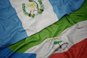 waving colorful flag of equatorial guinea and national flag of guatemala.