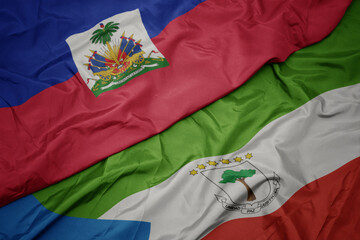 waving colorful flag of equatorial guinea and national flag of haiti.