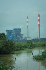 Obraz premium steam power plant in the middle of green environment.