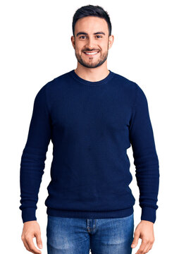 Young handsome man wearing casual clothes with a happy and cool smile on face. lucky person.