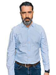 Middle aged man with beard wearing business shirt depressed and worry for distress, crying angry and afraid. sad expression.