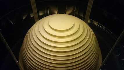 Closeup of a tuned mass damper with dark background