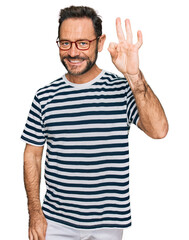 Middle age man wearing casual clothes and glasses smiling positive doing ok sign with hand and fingers. successful expression.
