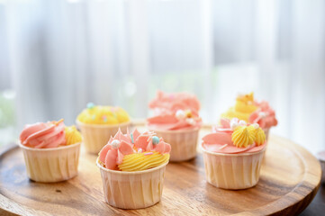 Tasty yummy homemade cupcake on a wooden tray. Sweets and dessert concept