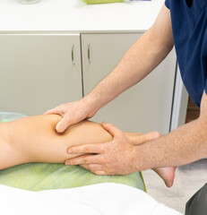 Obraz na płótnie Canvas Massage or rehabilitation therapist hands on female leg