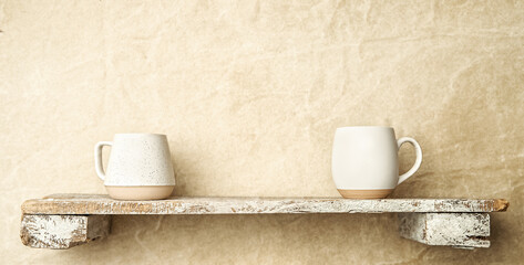 white ceramic cups on a shelf, copy space for promo or ad, banner
