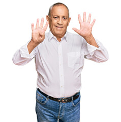 Fototapeta premium Handsome senior man wearing elegant white shirt showing and pointing up with fingers number nine while smiling confident and happy.
