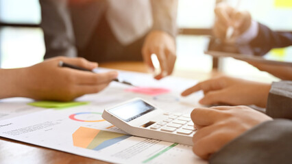 A female accountant is in the financial and accounting meeting with her team. cropped