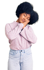 Fototapeta na wymiar Young african american girl wearing casual clothes sleeping tired dreaming and posing with hands together while smiling with closed eyes.