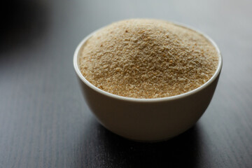  raw breadcrumbs in  small white bowl