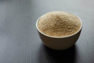  raw breadcrumbs in  small white bowl