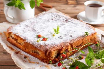 Clasic sponge cake, selective focus. Homemade pie on wooden background