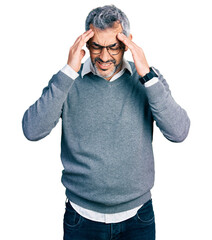Middle age hispanic with grey hair wearing glasses with hand on head, headache because stress. suffering migraine.