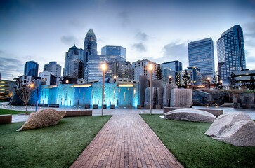 Narrow road in a park leading to downtown Charlotte city, with skyscrapers, North Carolina