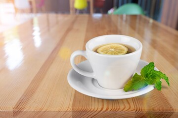 Ice tea with mint in cup with fresh mint leaves around. Homemade cold refreshing drink.