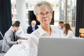 Senior businesswoman as boss with laptop pc