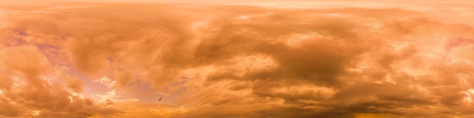 Golden glowing red orange overcast sunset sky panorama. Hdr seamless spherical equirectangular 360 panorama. Sky dome or zenith for 3D visualization and sky replacement for aerial drone 360 panoramas.