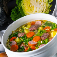 delicious savoy cabbage soup in white vase