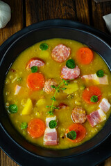 Hearty rustic pea soup with bacon and sausage