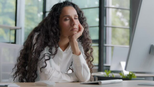 Tired sleepy lazy bored woman manager sitting in office falling asleep at workplace exhaustion from overloaded overworked businesswoman feels fatigue closes eyes sleeping on arm at desk near computer