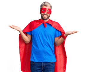 Young blond man wearing super hero custome clueless and confused expression with arms and hands raised. doubt concept.