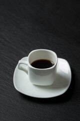 Obraz na płótnie Canvas close-up shot of cup of coffee on black background