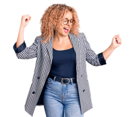 Young blonde woman with curly hair wearing business jacket and glasses dancing happy and cheerful, smiling moving casual and confident listening to music