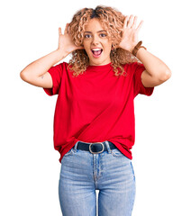 Young blonde woman with curly hair wearing casual red tshirt smiling cheerful playing peek a boo...