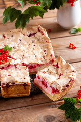 Redcurrant cheesecake on wooden table. Pieces of sweet homemade currant pie