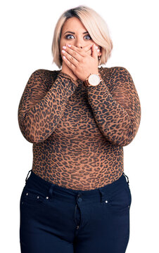Young blonde plus size woman wearing casual leopard t-shirt shocked covering mouth with hands for mistake. secret concept.